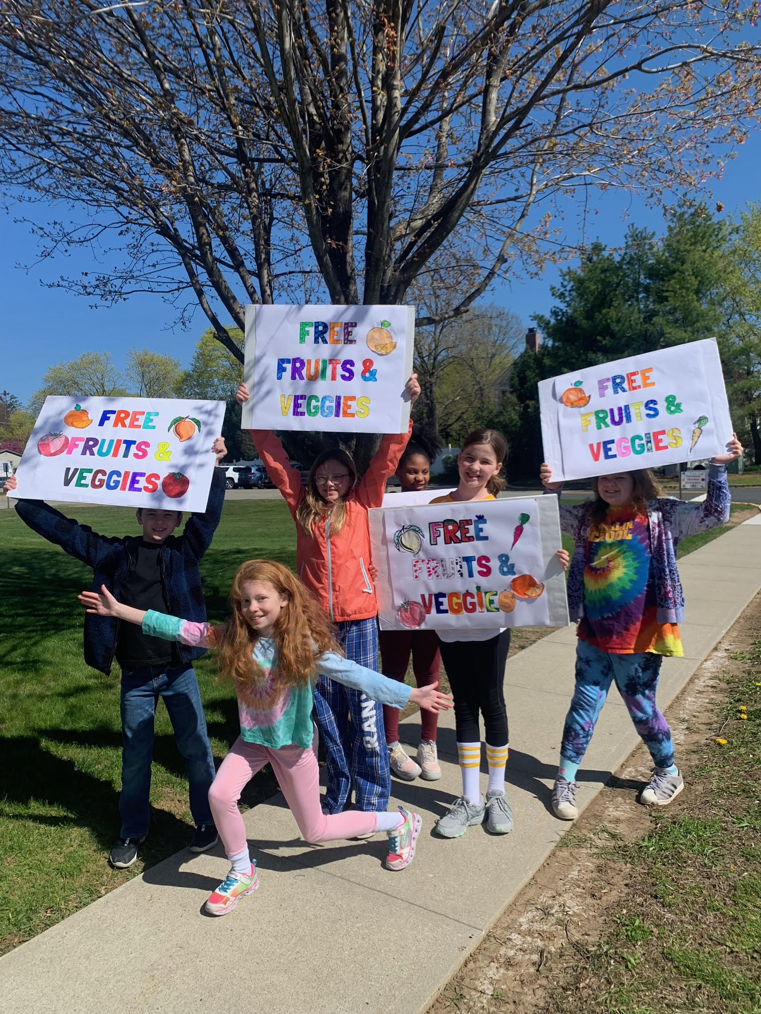  Franklin Early Act members held up signs to encourage people to stop into the Farmers Market